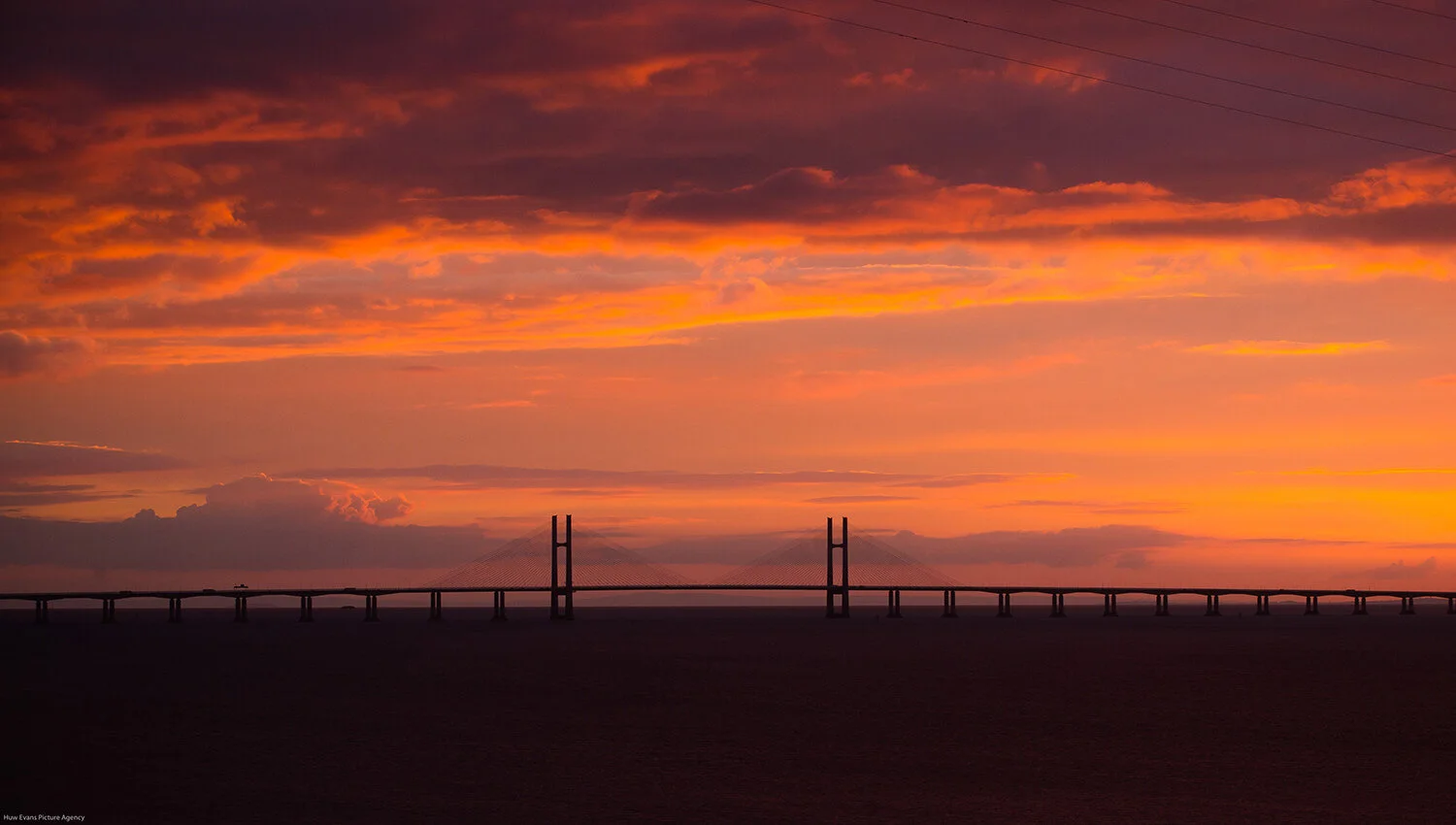 Sun sets behind the prince of wales bridge formerly second severn crossing