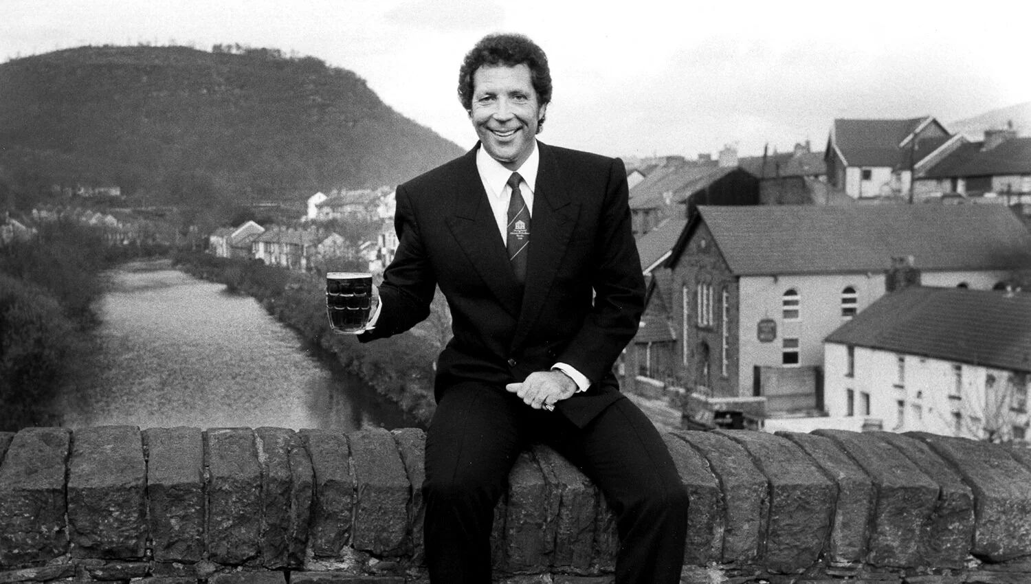 Tom jones enjoying a pint on the old bridge in pontypridd